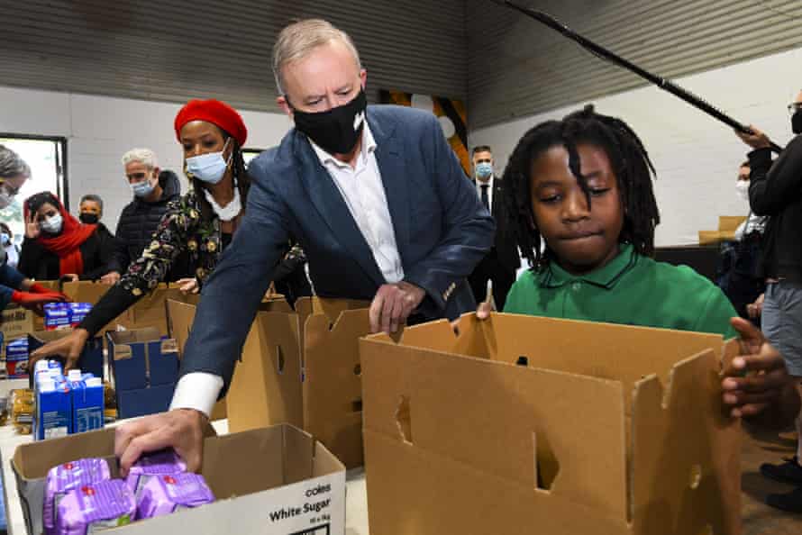 Labor leader Anthony Albanese helps volunteers packing food hamper boxes as he visits Addison Road Community Centre in Sydney.