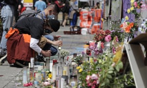 People light candles at a growing memorial to victims of police violence in Chaz.