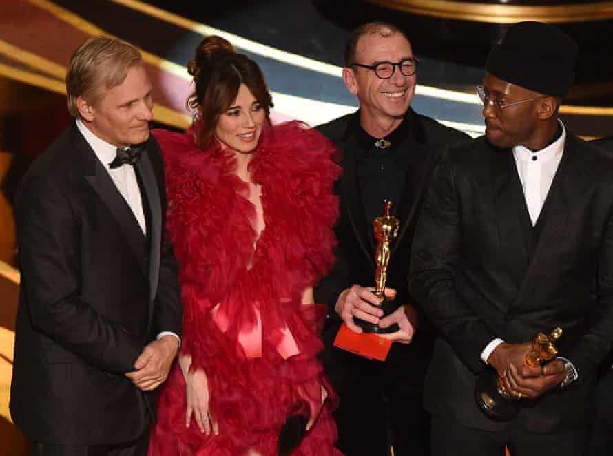 Cast members of Green Book, Viggo Mortensen, left, Linda Cardellini and Mahershala Ali, right, celebrate the best picture award.