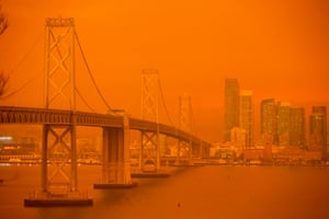 San Francisco, US. The San Francisco Bay bridge and city skyline are obscured in orange smoke and haze as more than 300,000 acres burn across the California