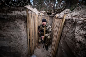 A solider on the outskirts of Kyiv in a defensive trench preparing for a possible attack by Russian troops.