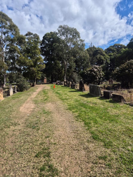 A walkway beside headstones