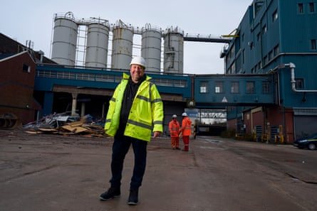Man in hi-vis stands in front of Unilever soap factory site