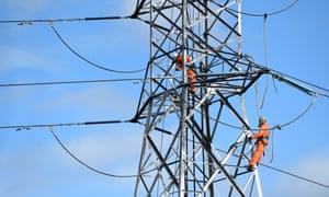 Workers on a high-tension electricity pylon