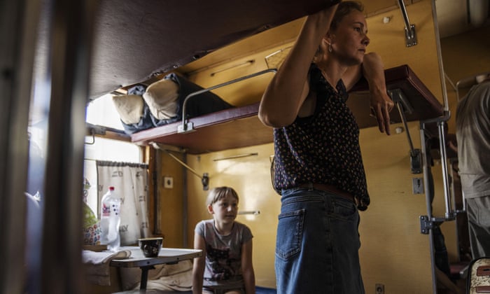 Internally displaced people board a train heading to Dnipro, at the Pokrovsk train station, Donetsk region, eastern Ukraine.