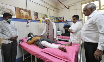 Narendra Modi (centre) meets a survivor of the bridge collapse at a hospital in Morbi.