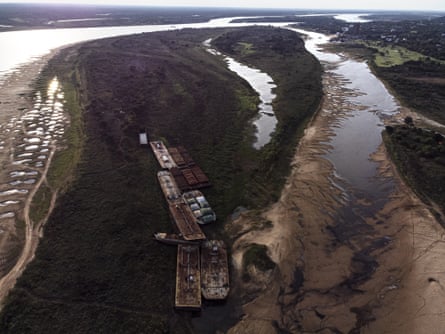 Barges lay stranded next to one of the branches of the Paraguay river that has gone dry, in Lambare, Paraguay, on 14 September.
