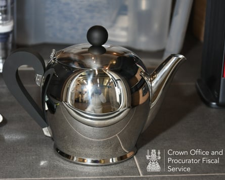 Silver Alessi teapot. Police photographer, in protective clothing, can be seen reflected in the teapot