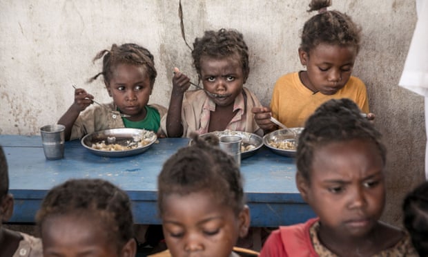 Schoolchildren in the Amboasary-South district of Madagascar eat lunch provided by the World Food Programme.