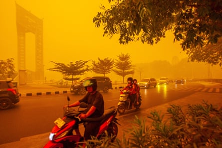 Motorists ride through thick haze from wildfires in Palangkaraya, Central Kalimantan, Indonesia. Photograph: GENDES/EPA