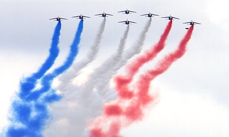 The French air force aerobatic display team, La Patrouille de France, perform a flyby in Alpha jets over Paris on Bastille Day. 