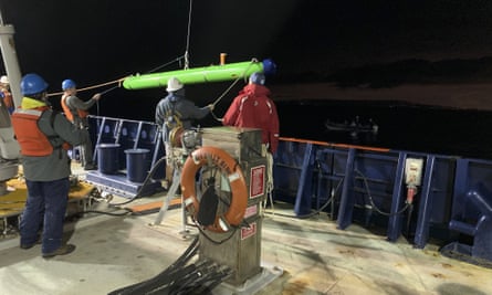Researchers on the research vessel Sally Ride deploy an autonomous underwater vehicle near Santa Catalina Island.
