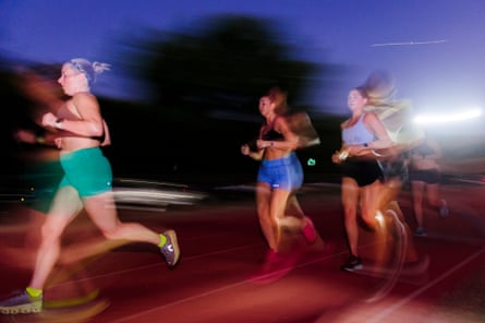 Mallory Horton, Meagan Sasse, and Emily Lamas, members of the Rogue Running club, run on the Austin high school track.