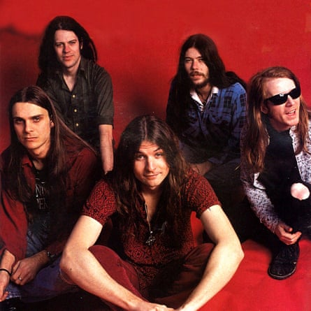 Five members of Tumbleweed crouching against red background
