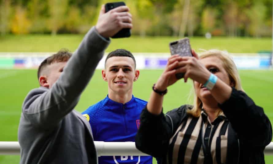 England’s Phil Foden has his picture taken with fans at St George’s Park