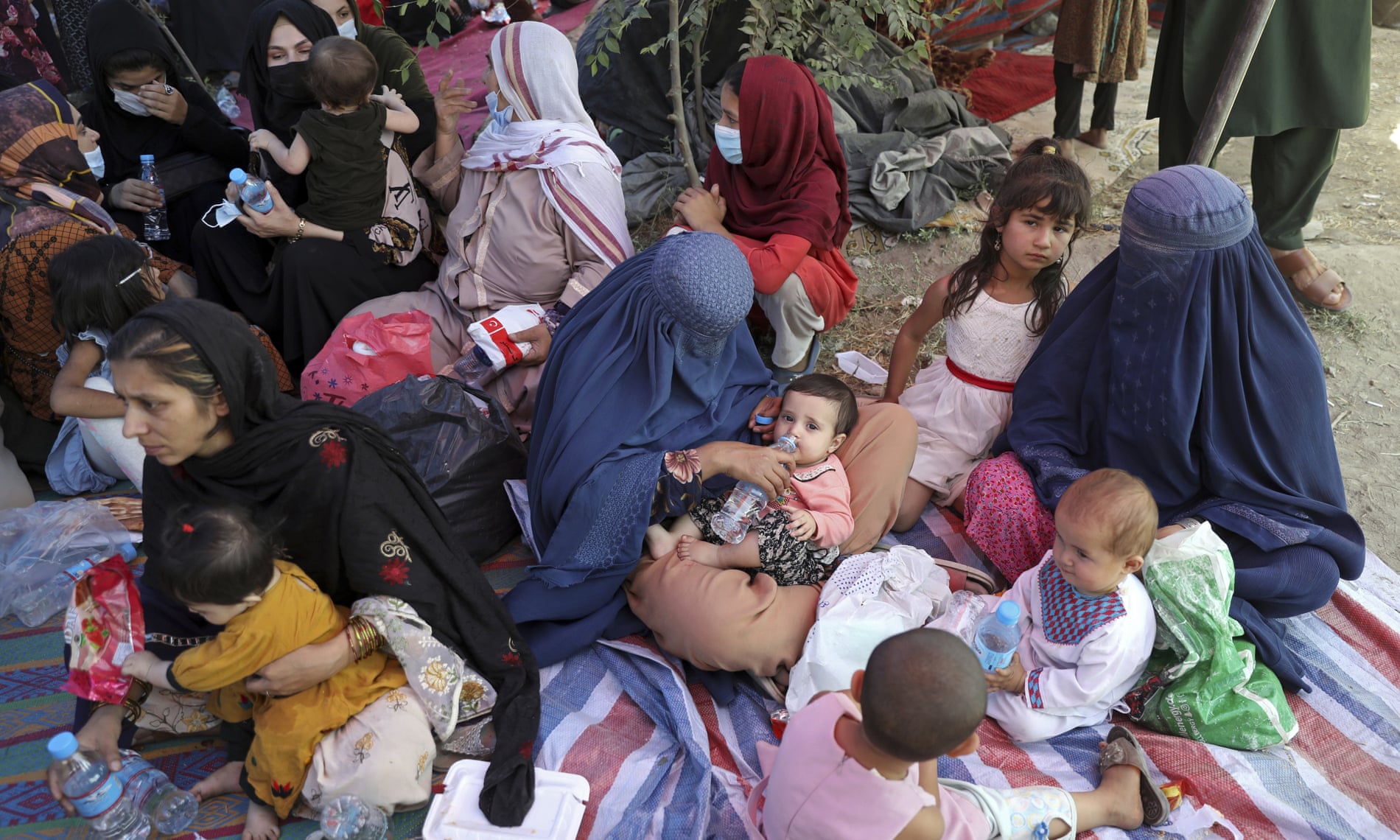 Mothers and children displaced by fighting in the northern provinces camped in a Kabul park.
