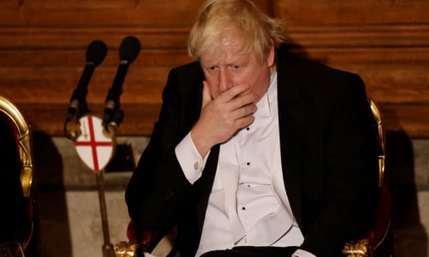 Boris Johnson holds a hand to his mouth during the Lord Mayor’s Banquet in central London in November 2021
