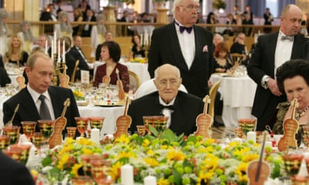 Vladimir Putin with Prigozhin (second right) in the background.