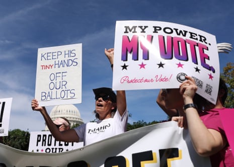Protesters outside the US Capitol hold signs supporting mail-in voting rights