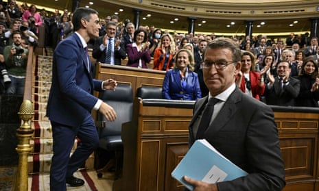 Spain's acting Prime Minister Pedro Sanchez (L) is congratulated by Partido Popular (PP) leader Alberto Nunez Feijoo after winning a parliamentary vote to elect Spain's next premier, at the Congress of Deputies in Madrid on November 16, 2023.