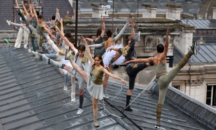 Dancers perform on a rooftop.