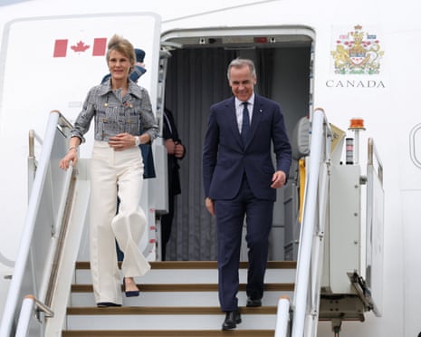Canadian Prime Minister Mark Carney and his wife, Diana Fox Carney, disembarking a plane