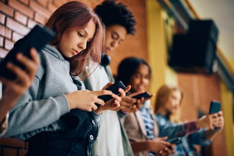 teenagers looking at their phones