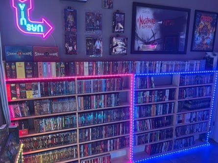 shelves of dvds lit by neon lighting