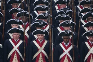Soldiers dressed in Revolutionary War uniforms march in the parade.