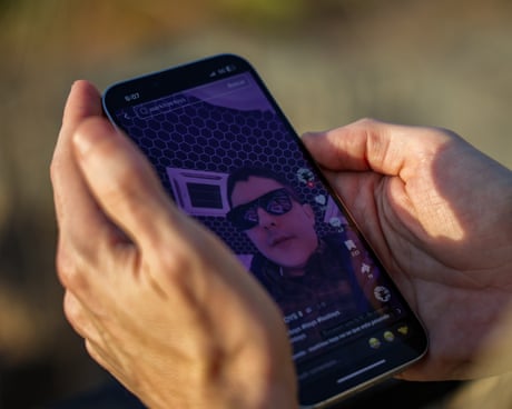 a person holds a phone with a video playing on it