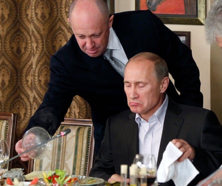 Yevgeny Prigozhin serves the Russian prime minister Vladimir Putin at his restaurant in 2011.