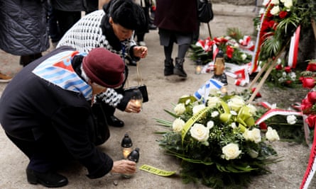 Survivors of Nazi concentration camps lay flowers in the grounds of Auschwitz-Birkenau on the 78th anniversary of its liberation, in Poland, 27 January 2023.