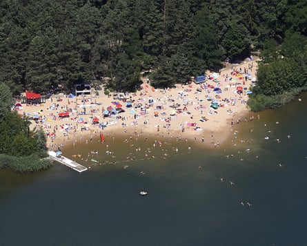 Aerial view of the lake with a sandy area leading into the water