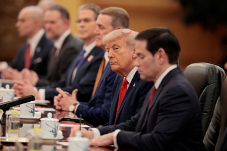 Donald Trump sat with officials at the Great Hall of the People in Beijing.