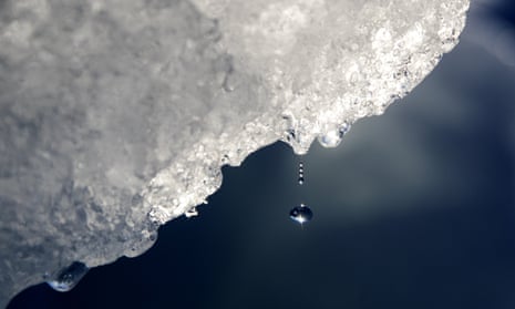 A drop of water falls off an iceberg melting in the Nuup Kangerlua Fjord in south-west Greenland