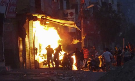 A shop is set on fire during ongoing violence in Delhi, India