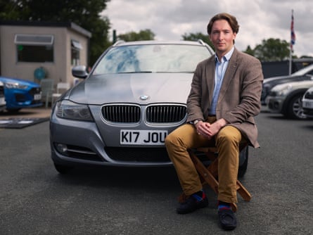 Kit Joubert sitting in front of his silver BMW with the number plate “K17 JOU”
