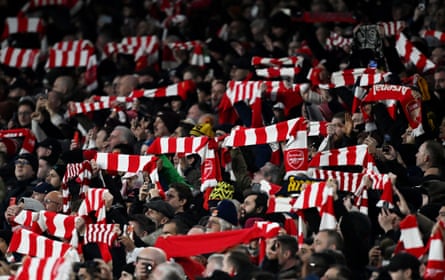 Arsenal fans hold scarves up inside the Emirates before the match against Manchester United.