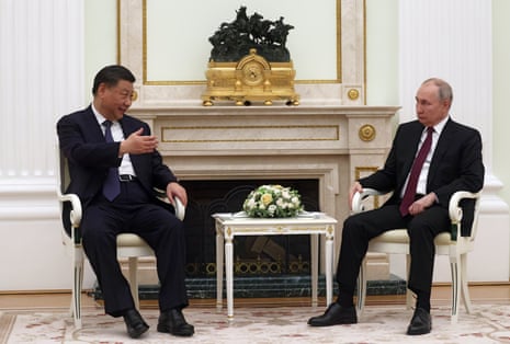 Chinese President Xi Jinping gestures while speaking with Russian President Vladimir Putin during their meeting in Moscow Kremlin.