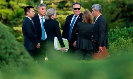 The US secretary of state, Mike Pompeo, in sunglasses, speaks with his aides after a meeting in Pyongyang with senior North Korean official Kim Yong-chol.
