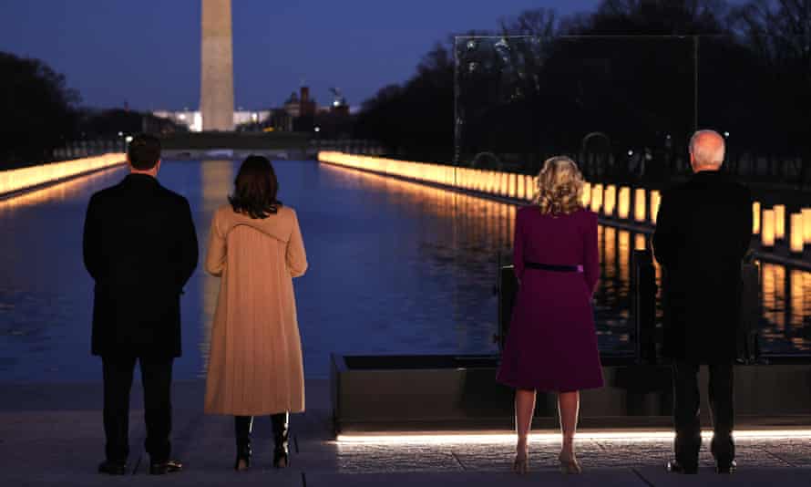 Kamala Harris, second from left, wears a camel coat featuring a water-like design at a memorial for victims of the coronavirus pandemic at the Lincoln Memorial on 19 January.