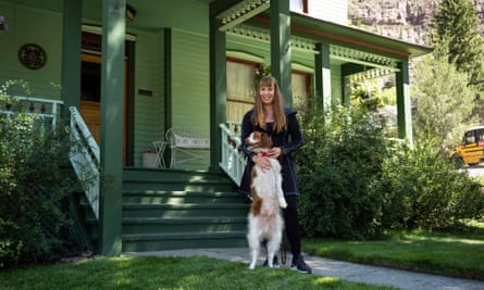 Kentee Pasek and her dog Dexter, standing on his two hind legs by her porch in Ouray Colorado