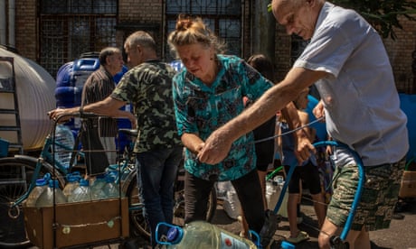 Residents in Nikopol, Ukraine, collect water. Russia has bombarded dams and water treatment plans in Ukraine.