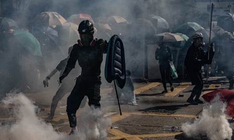 Protesters stand amid teargas fired by police during an anti-government rally in Hong Kong in November.