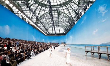 Models walk along a fake beach at Karl Lagerfeld’s SS19 collection for Chanel at the Grand Palais, October 2018