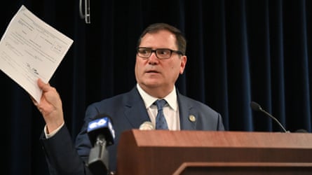 John Sarcone III holding up a document