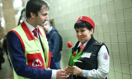 A Moscow Metro employee gives tulips to a colleague at Komsomolskaya Station of the Moscow Metro to mark Women’s Day.