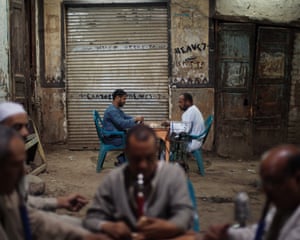men playing an evening game of dominos in an Egyptian street.