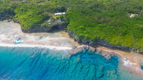 An aerial view of sea and forested shore