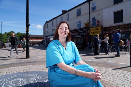 Rose Marley of Co-operatives UK sits smiling in Middleton town centre